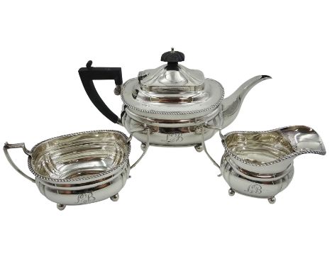 Early 20th century silver three piece tea service, comprising teapot, milk jug and twin handled sucrier, each of oval form wi