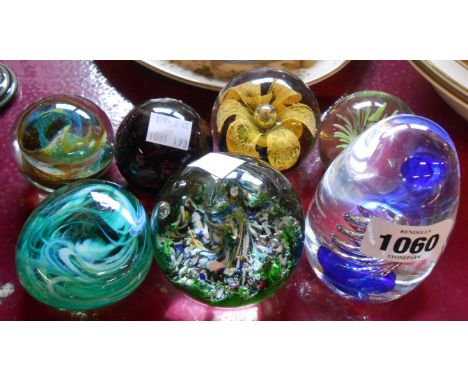Seven decorative glass paperweights including Isle of Wight and Caithness examples