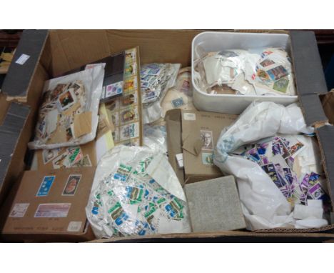 A box containing a large collection of recovered world stamps, loose, on sheets and paper, some South Africa bundleware and o