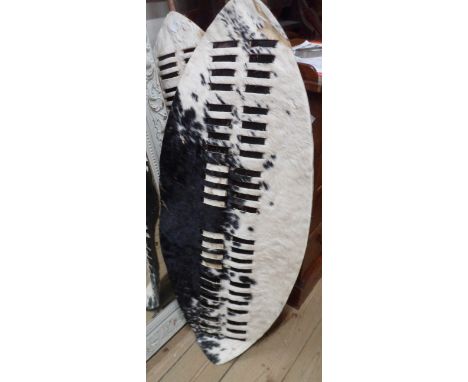 Two vintage tourist ware Zulu shields with zebra hide body on a wooden and basketwork frame