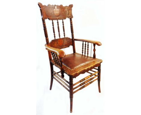 A late 19th Century American 'gingerbread' high rope-twist spindle back elbow chair with later studded leather seat panel, se