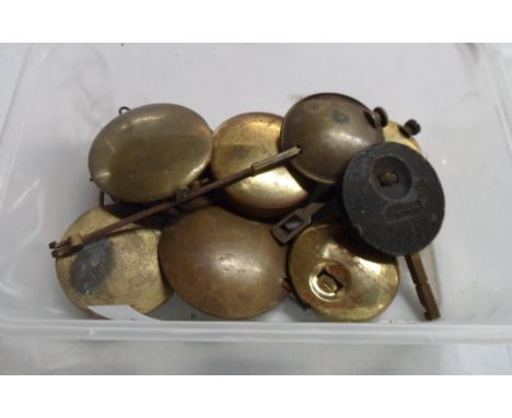 A tub containing a quantity of brass and other clock pendulums