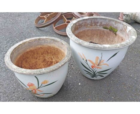 Two ceramic garden planters decorated with floral sprays