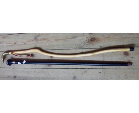 A modern walking stick with cast brass duck form handle - sold with another ebonised example