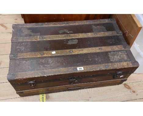 An 82cm old iron bound travelling trunk containing various textiles and other items