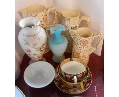 A selection of ceramic items including a set of three graduated brown transfer printed jugs in the Aesthetic Movement manner,