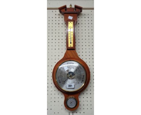 A modern polished wood Weathermaster banjo barometer/thermometer with visible aneroid works and hygrometer dial under