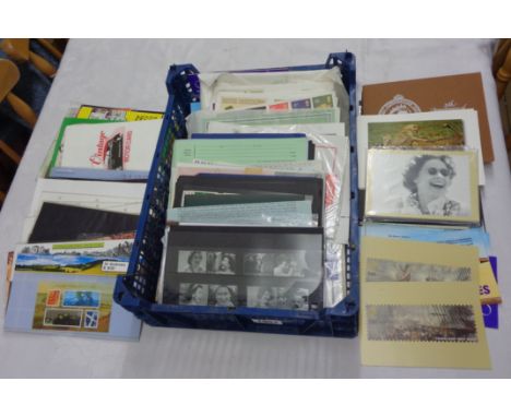 A crate containing a collection of mint Commonwealth royal commemorative stamps in stock sleeves and presentation packs, also