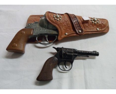 A vintage Super Cowboy western style toy cap gun - sold with a smaller similar