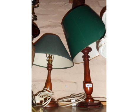 A turned wood table lamp of candlestick form - sold with another similar - both with green shades