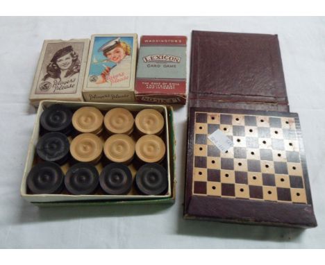 A small selection of games including wooden draughts set, portable checkers set, two sets of Player's Navy cut advertising ca