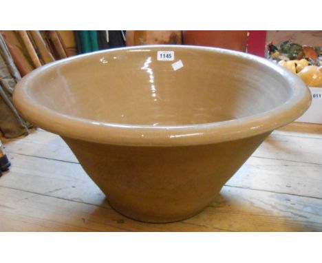 A large stoneware cream pan with glazed interior - later drill hole