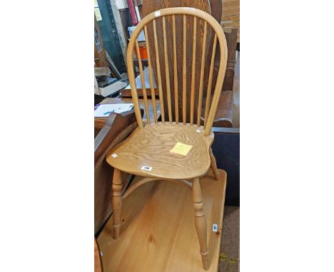 A reproduction hoop stick back standard chair with moulded solid elm seat, turned supports and crinoline stretcher