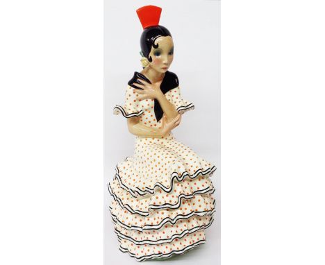 A 1930's Art Deco Lenci Pottery model of a flamenco dancer, model seated wearing a white tiered dress with red polka dots, bl