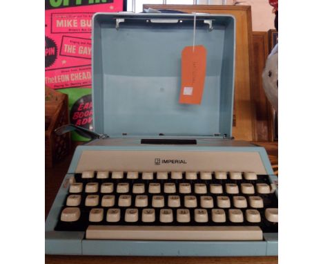 A vintage Imperial Litton typewriter in baby blue colourway with matching plastic case