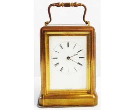 A brass and bevelled glass cased carriage clock with eight day bell striking movement