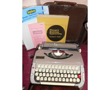 A vintage cased Scheidegger Princess-Matic portable typewriter - mechanism seized - sold with instructions, a copy of Pitman'