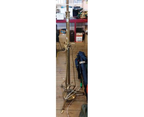 A Victorian brass telescopic lamp standard, set on tripod base with circular disc