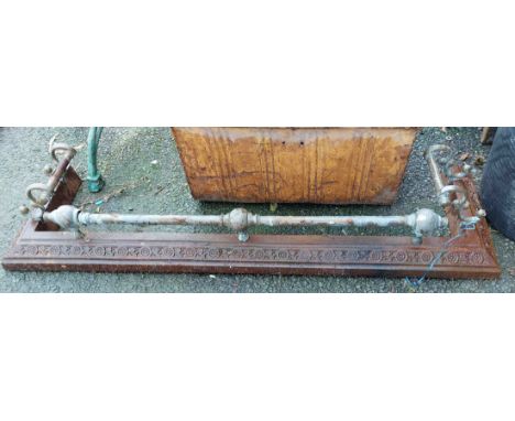 A small cast iron fireback with portcullis and rose decoration and a painted black and gold finish - sold with a brass and ca
