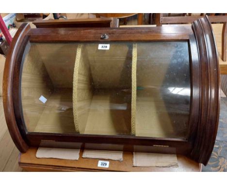 A 48cm early 20th Century mahogany bow front wall mounted corner cabinet with material lined interior enclosed by a glazed pa