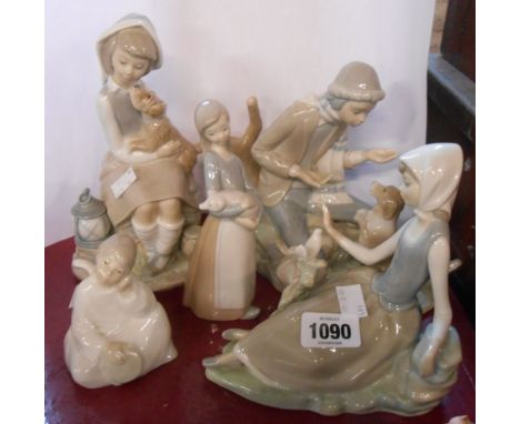 A Lladro figurine of a girl holding a puppy - sold with two similar Lladro figurines and two Nao figurines