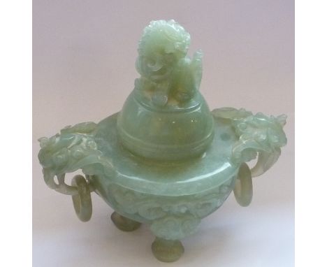 A Chinese carved green hardstone tripod Censer and cover, the cover surmounted with a Karashishi above a two-handled body and