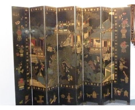 A large and  fine seven-fold Chinese ebonised wooden Screen; finely incised and polychrome decorated with figures in various 