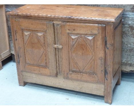An unusual 18th century French Canadian (possibly Quebec) pine Side Cabinet, the moulded top above two doors, each with centr