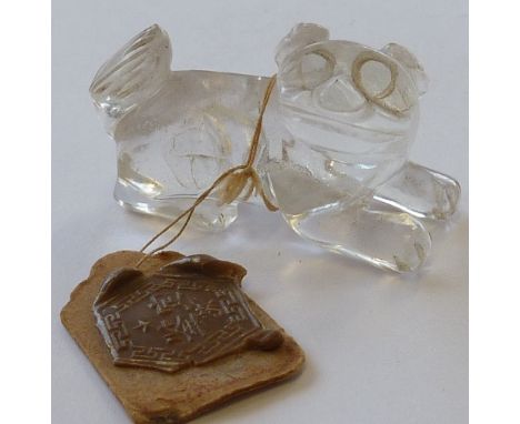 A small Chinese rock crystal Carving of a recumbent Karashishi, together with seal label, 4cm 