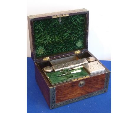 A good early-19th century rosewood and brass bound Dressing Chest having Bramah lock, the hinged top section with recessed fl