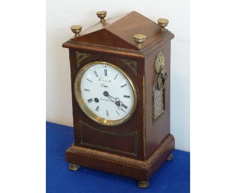 An early-19th century period mahogany and brass inlaid eight-day Mantel Clock, the architectural-style pediment with three in