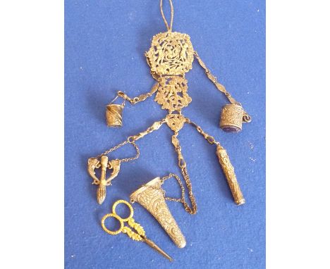 A late-19th century hallmarked silver Chatelaine, three sectional pieced articulated panels decorated with cherubic figures a
