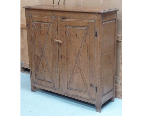 A late-18th century French Canadian pine Side Cabinet (possibly Quebec), the moulded top above two full-height doors, each wi