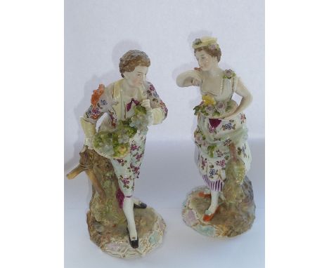 A pair of 19th century Continental hand-decorated porcelain Figures in early style dress, the male with a grapevine and the f