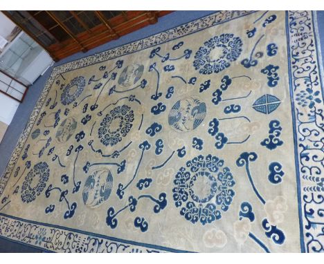 A large and unusual hand knotted Eastern Carpet, the Chinese style mon within stylised Ruyi shaped cloud heads and four furth