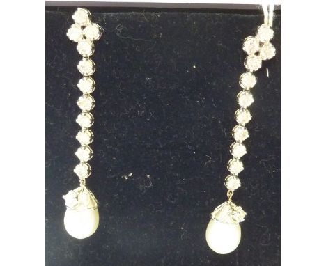A pair of 18-carat white gold Earrings, each set with twelve diamonds and a large pearl (approx. 4.5 carat diamonds)