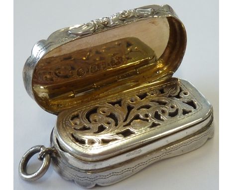 A mid-19th century oval-ended silver Vinaigrette, with engine-turned base and lid, monogrammed cartouche EG, and bright-cut s
