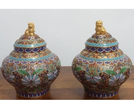 A fine pair of Chinese cloisonné enamel ovoid Vases and Covers, the finials as gilded Karashishi above domed covers and styli