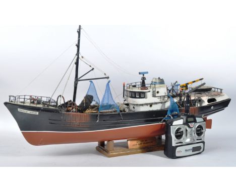 A vintage Radio Controlled RC model trawler fishing boat. Highly detailed model with a large mast towards the front, fishing 