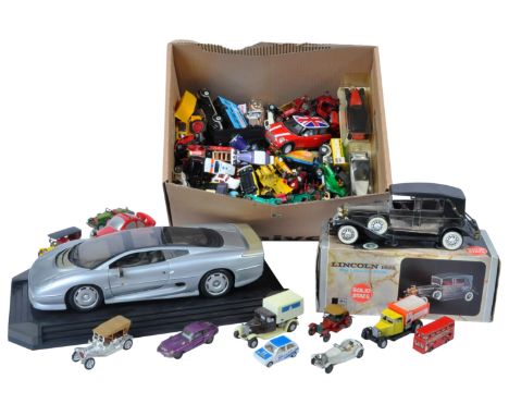 A large collection of assorted vintage unboxed diecast models to include; a large 1/12 scale Maisto diecast model car on plin