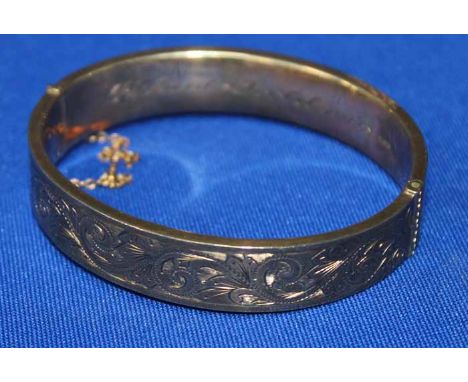 NINE CARAT GOLD BANGLE
engraved with scrolling decoration, hallmarked, 18.4g