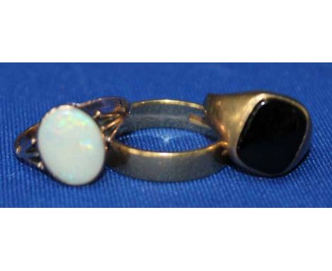 GENTLEMAN'S EIGHTEEN CARAT GOLD WEDDING BAND
along with a nine carat gold opal ring and a nine carat gold signet ring