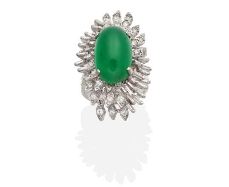 An 18 Carat White Gold Emerald and Diamond Cluster Ring, an oval cabochon emerald in a claw setting to an abstract border of 