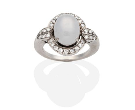 An Art Deco Star Sapphire and Diamond Cluster Ring, an oval cabochon grey star sapphire in a claw setting, within a border of