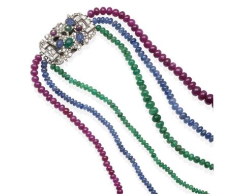 An 18 Carat White Gold Multi-Gemstone Necklace, graduated strands of emerald, sapphire and ruby beads knotted to a clasp set 