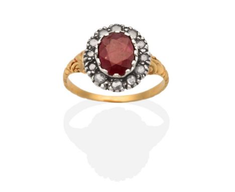 An Antique Ruby and Diamond Cluster Ring, an oval cut ruby in a collet setting, within a border of rose cut diamonds, to foli