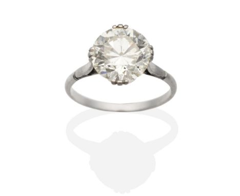 A Solitaire Diamond Ring, an old cut diamond in a triple claw setting, to tapering notched shoulders, estimated diamond weigh