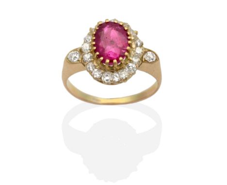 A Burmese Ruby and Diamond Cluster Ring, an oval cut ruby in a claw setting within a border of old cut diamonds, to diamond s