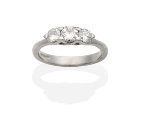 A Platinum Diamond Three Stone Ring, graduated round brilliant cut diamonds in claw settings, total estimated diamond weight 