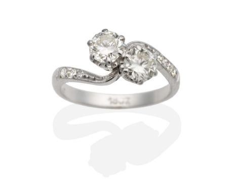 A Two Stone Diamond Crossover Ring, round brilliant cut diamonds in claw settings to diamond set bypass scroll shoulders, tot